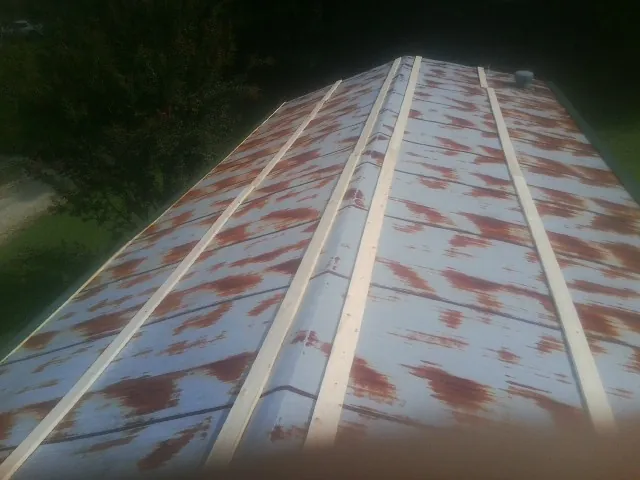 Rusted metal roof panels with new wood purlins before replacement — Storm Damage Roof Repair in Mahaffey by Roofing Brothers
