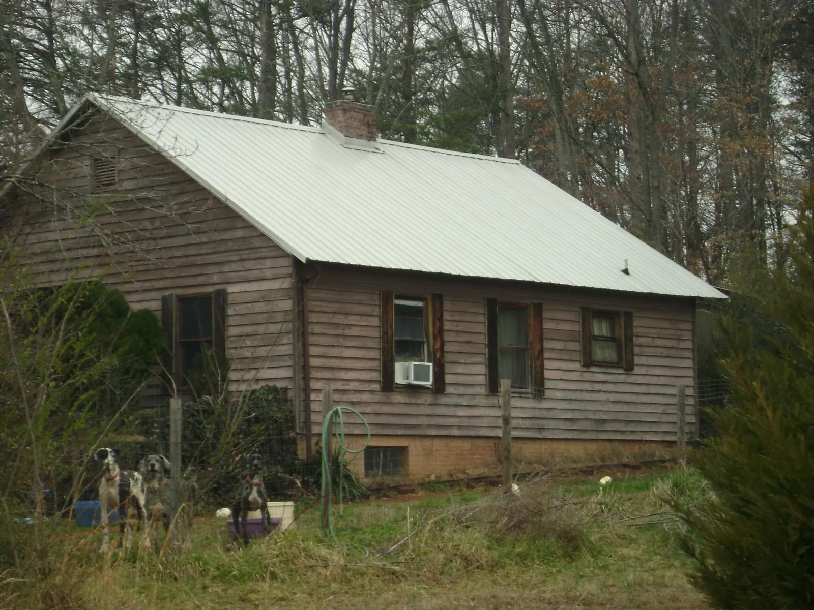White metal roof on an old wood sided farmhouse, from a Metal Roof Installation job in Mahaffey